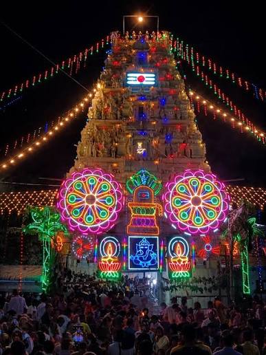 Gopuram lit with festival lights during the temple utsavam